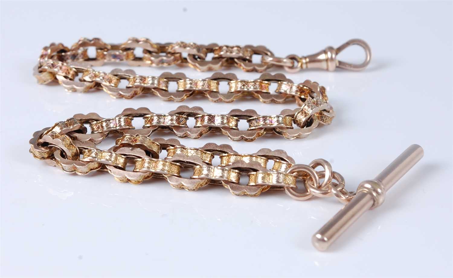 Lot 1315 - A 9ct gold fancylink watch chain with Albert,...