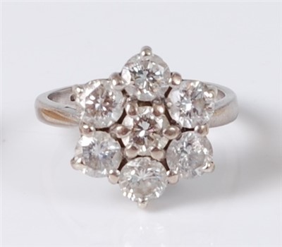 Lot 1271 - An 18ct white gold diamond set flower head...