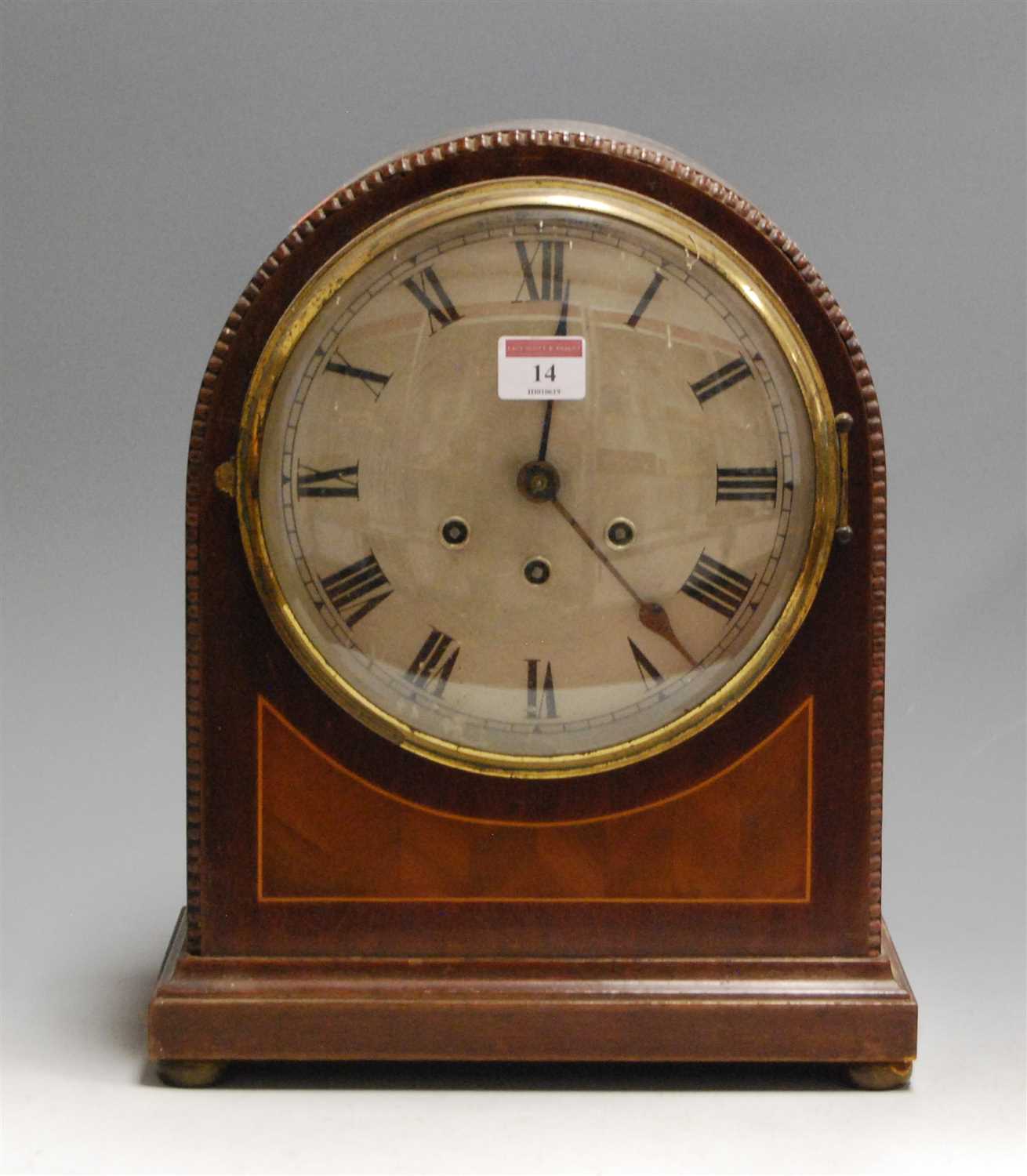 Lot 14 - A 1920s mahogany cased dome-top mantel clock,...