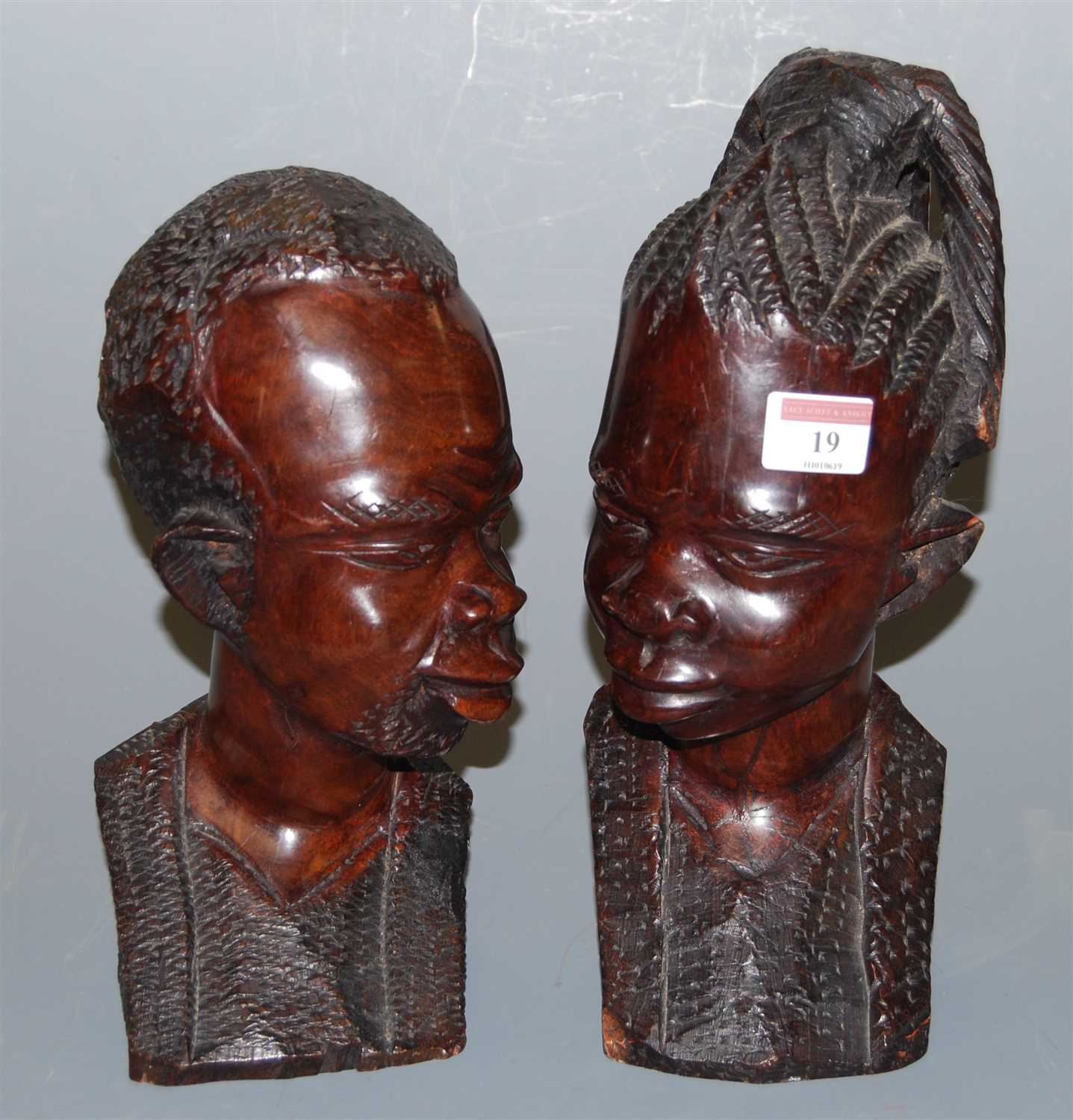 Lot 19 - A pair of African carved hardwood tribal busts,...