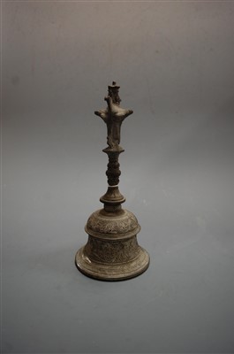Lot 20 - A Tibetan brass hand-bell, having all-over...