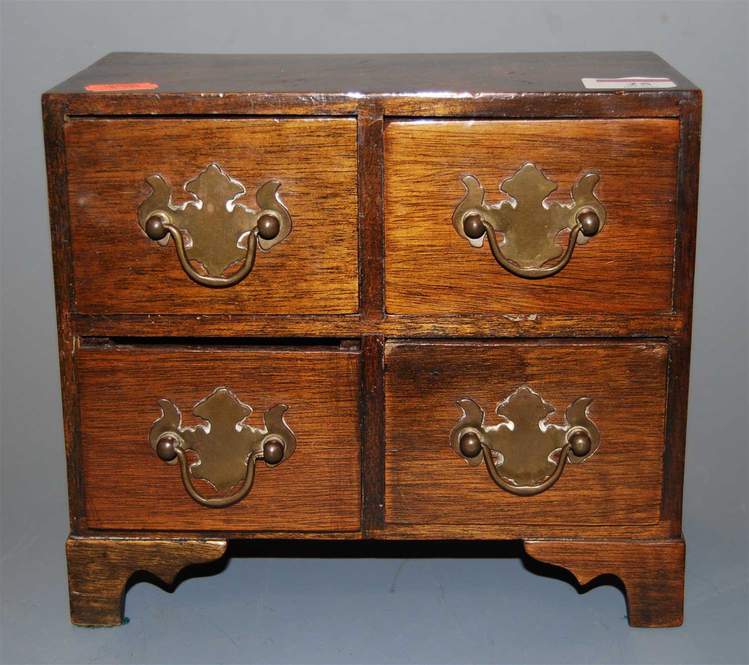 Lot 25 - A mahogany four drawer table-top jewellery...