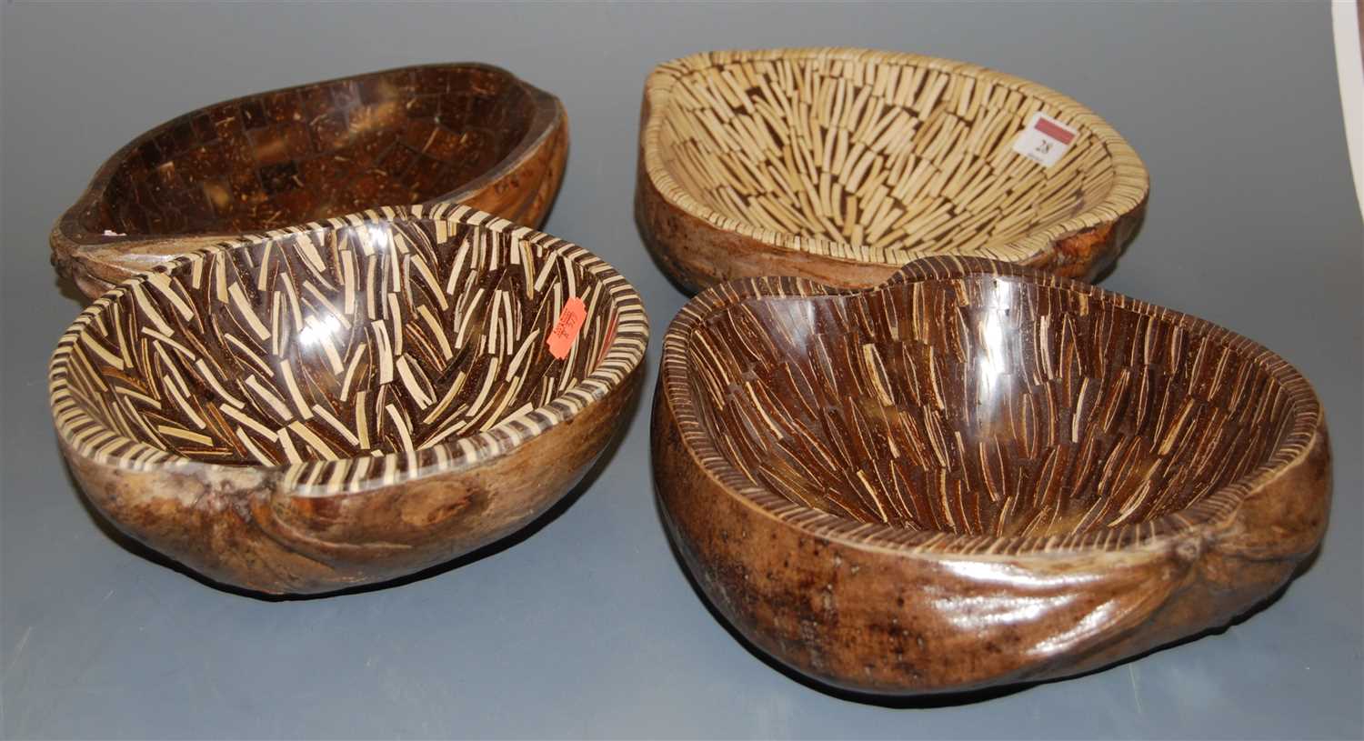 Lot 28 - A set of four coconut husk table bowls