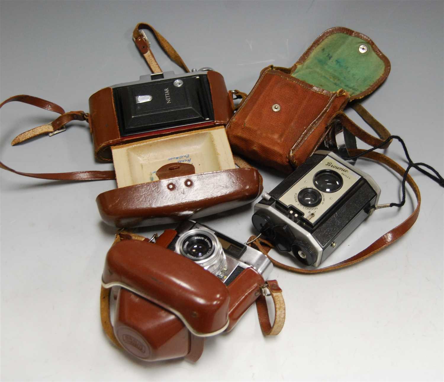Lot 33 - A Zeiss Ikon Nettar camera, in fitted leather...