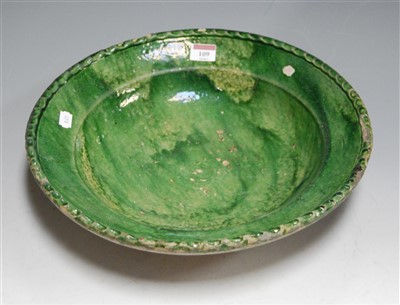 Lot 109 - A 19th century green glazed pottery charger,...