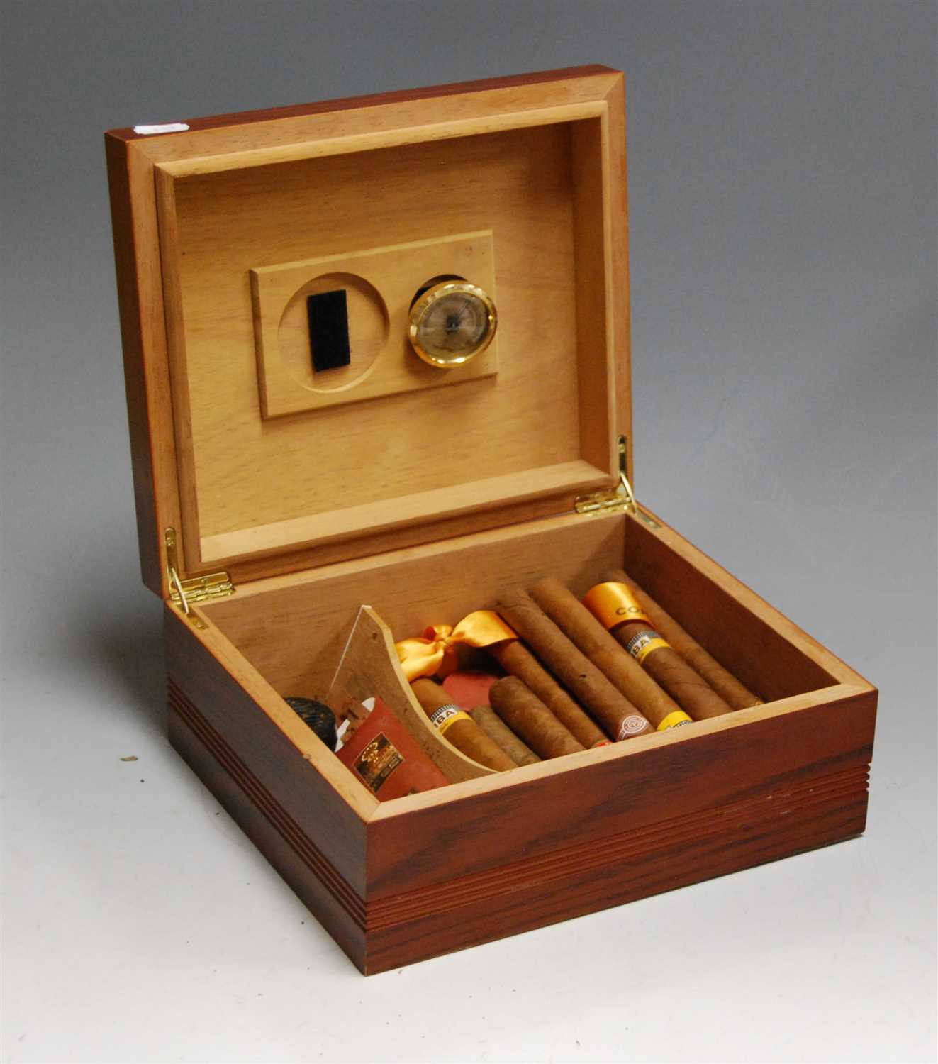 Lot 158 - A faux oak table-top cigar humidor, containing...