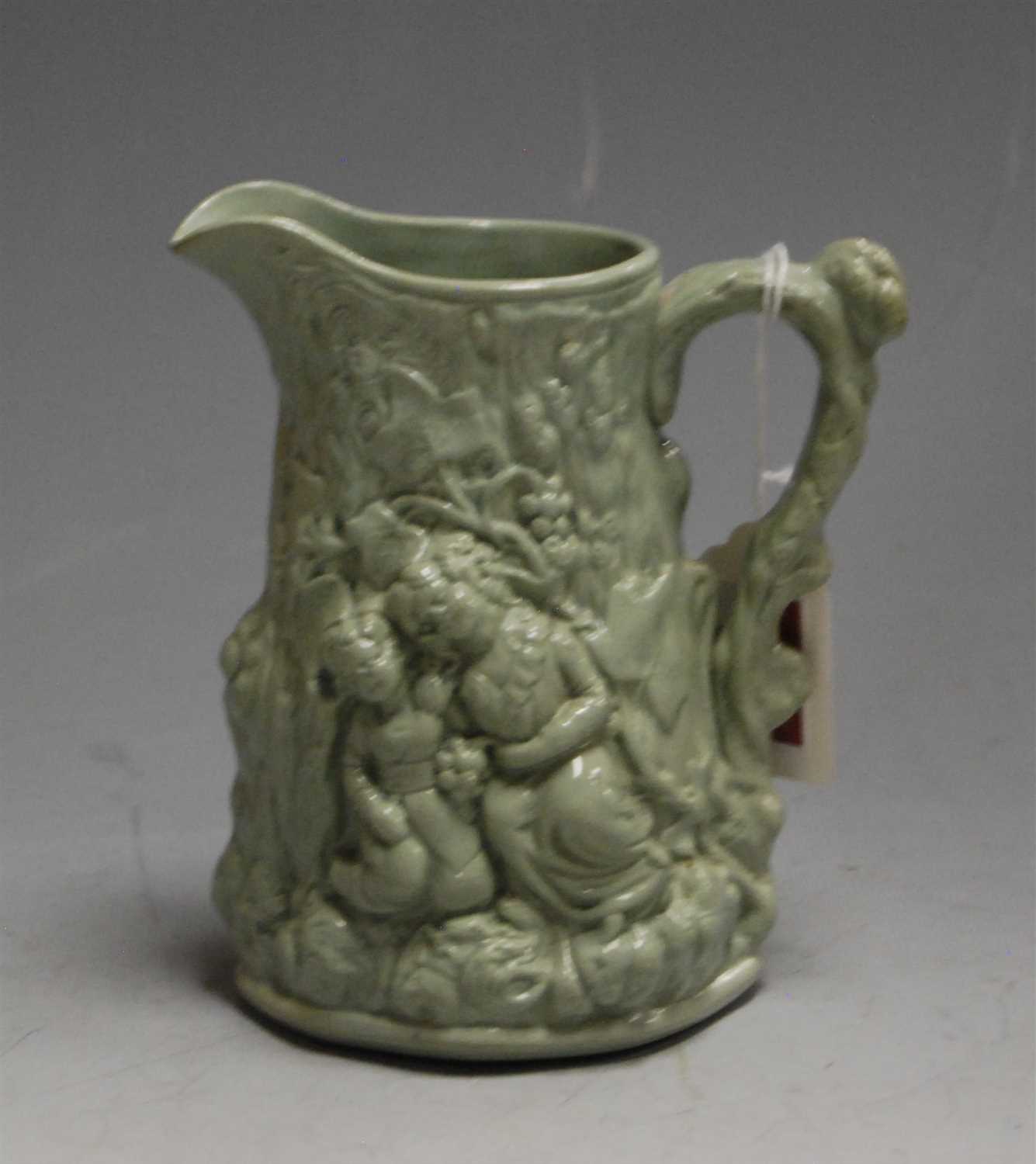 Lot 168 - A Victorian green glazed water jug, moulded in...