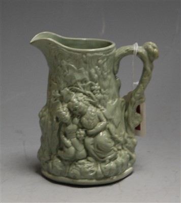 Lot 168 - A Victorian green glazed water jug, moulded in...