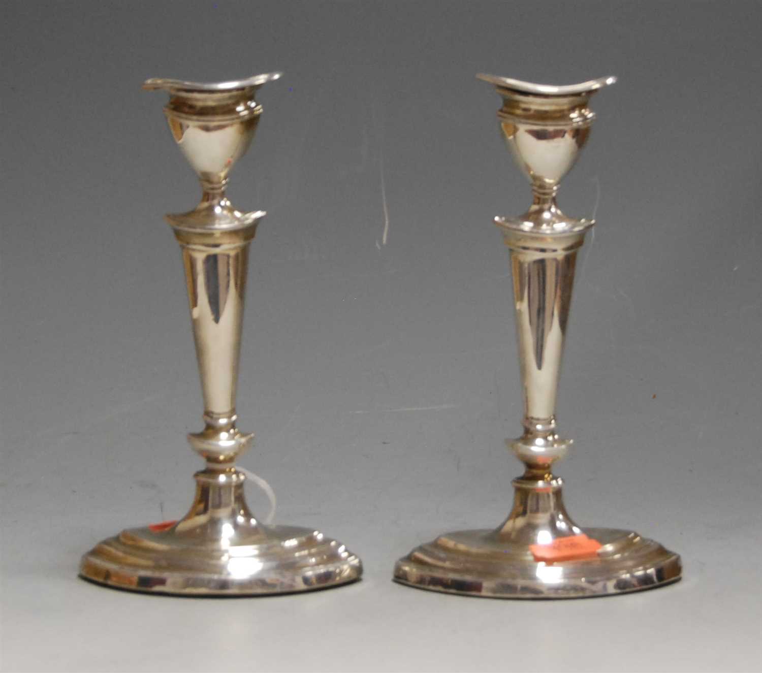 Lot 194 - A pair of George V silver table candlesticks...