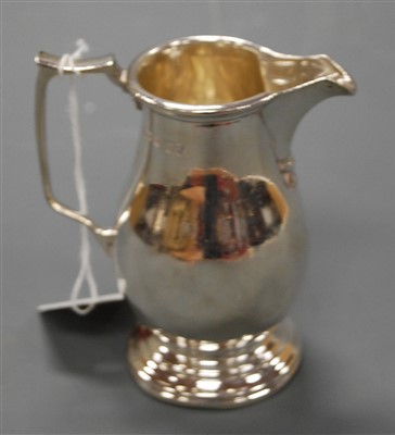 Lot 198 - A George VI silver helmet shaped cream jug by...