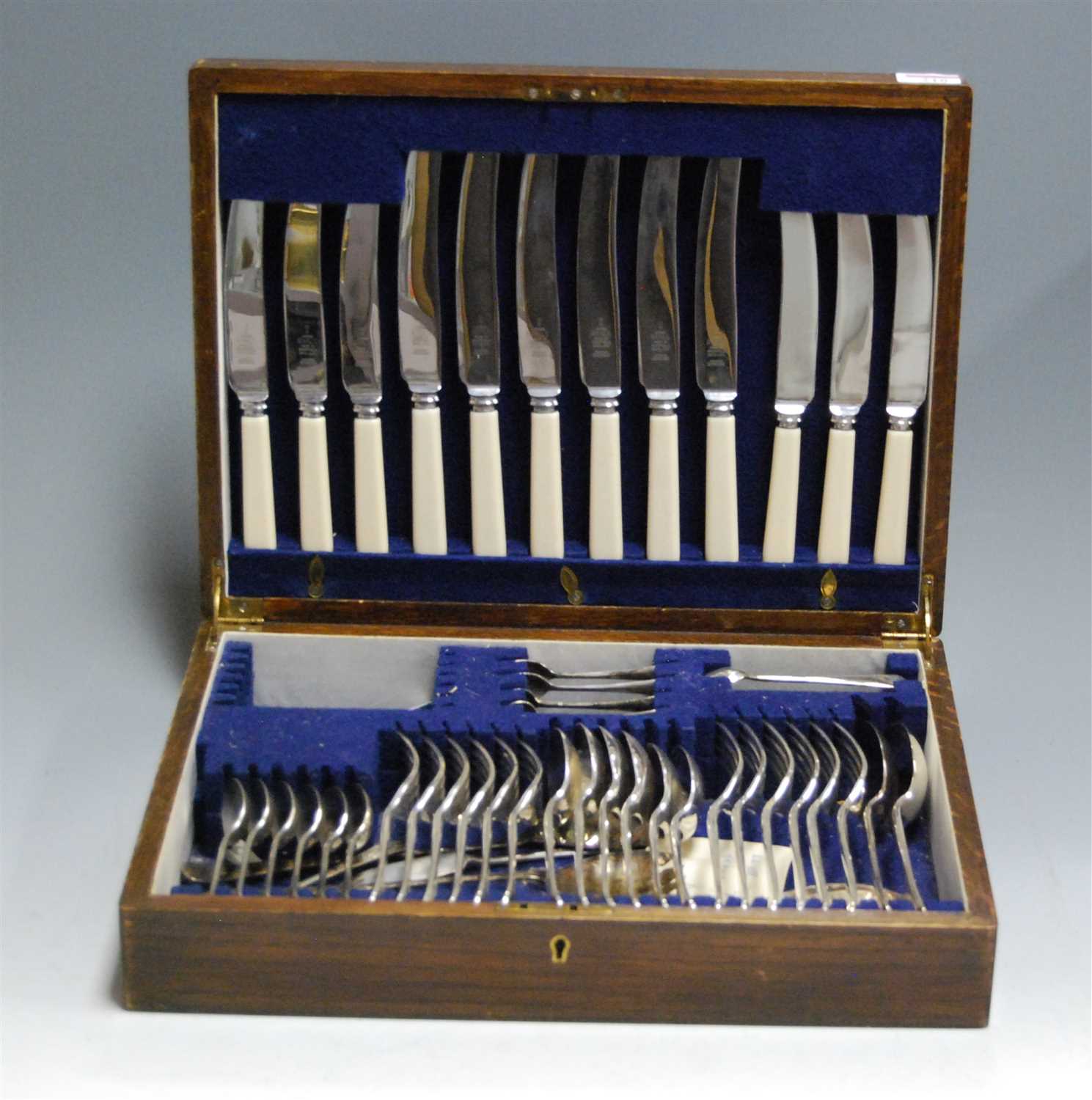 Lot 218 - A mid-20th century oak cased canteen of silver...