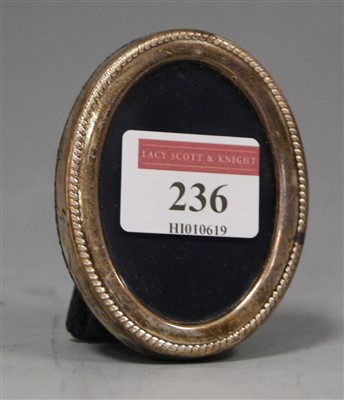 Lot 236 - A small modern silver clad oval easel...