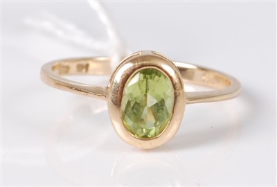 Lot 305 - A 14ct gold green peridot set dress ring, 1.5g,...
