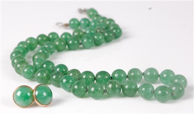 Lot 311 - A beaded and knotted green jade necklace, with...