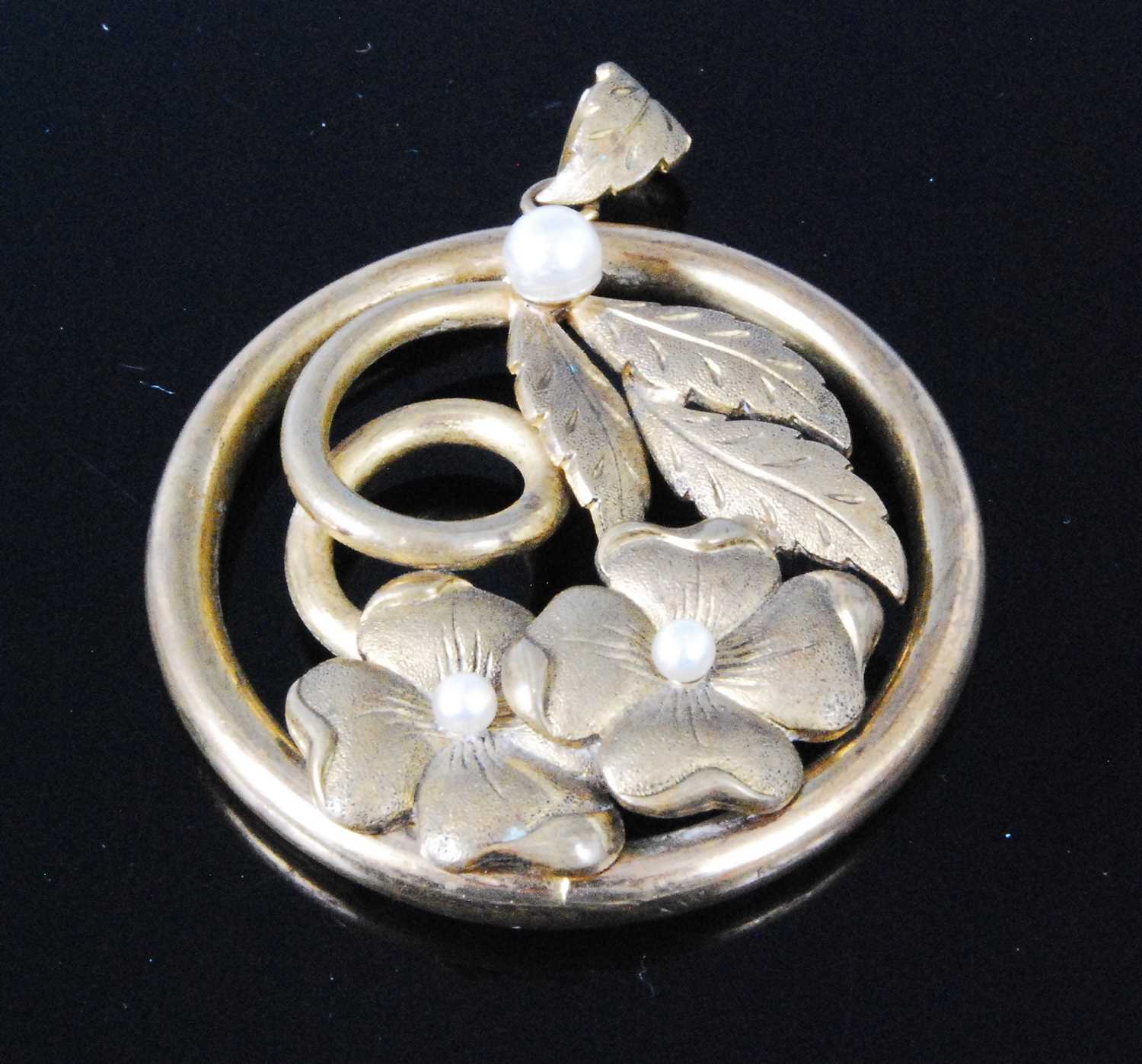 Lot 337 - A pinchbeck leaf and flower pendant, further...