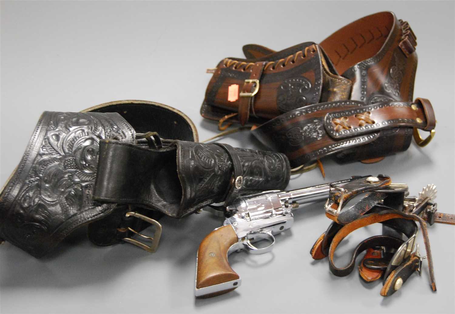 Lot 402 - A Spanish chromed model of a revolver in brown...