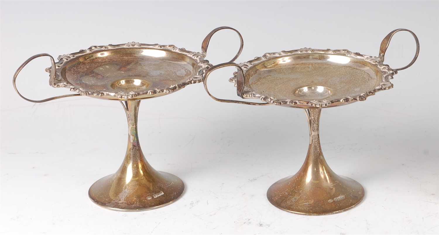 Lot 220 - A pair of Art Nouveau silver pedestal twin...