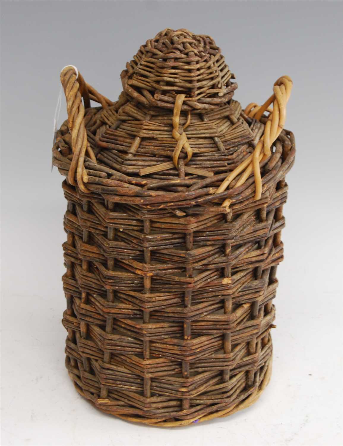 Lot 219 - A rum ration stoneware jar, in wicker carry...