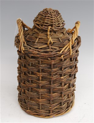 Lot 219 - A rum ration stoneware jar, in wicker carry...