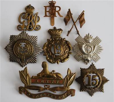 Lot 240 - A collection of cap badges and metal insignia,...