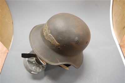 Lot 252 - A German Luftschutz steel helmet, with logo;...