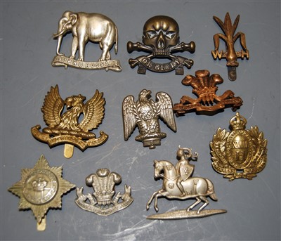 Lot 273 - A small collection of cap badges, to include...