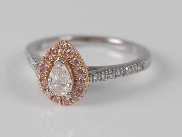 Lot 1173 - A platinum and 18ct rose gold pear shaped...