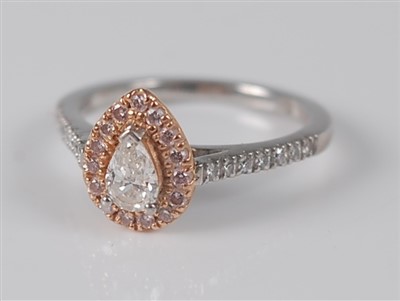 Lot 1173 - A platinum and 18ct rose gold pear shaped...