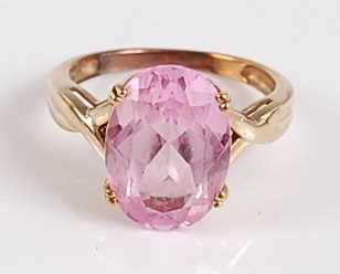 Lot 2504 - An oval synthetic pink sapphire dress ring,...