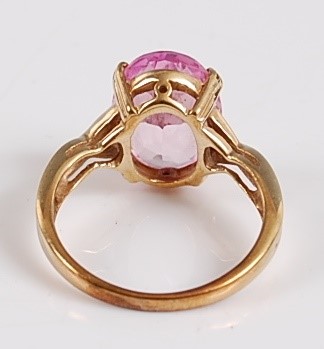 Lot 2504 - An oval synthetic pink sapphire dress ring,...