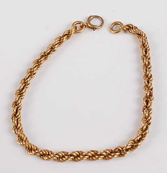 Lot 2510 - A yellow metal twisted rope link bracelet,...