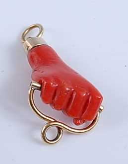 Lot 2507 - A carved coral pendant in the form of a closed...