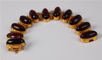 Lot 1175 - A yellow metal and cabochon ruby glass set...