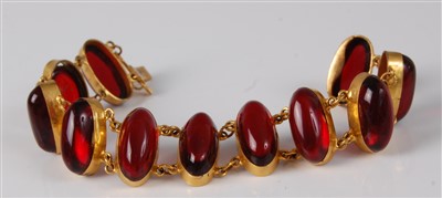 Lot 1175 - A yellow metal and cabochon ruby glass set...