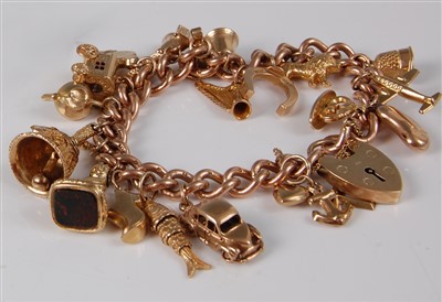 Lot 1179 - A 9ct gold charm bracelet, having heart shaped...
