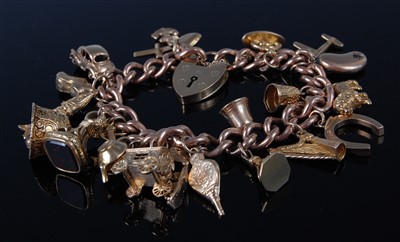 Lot 1179 - A 9ct gold charm bracelet, having heart shaped...