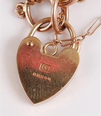 Lot 2544 - A 9ct gold gatelink bracelet, with heart...