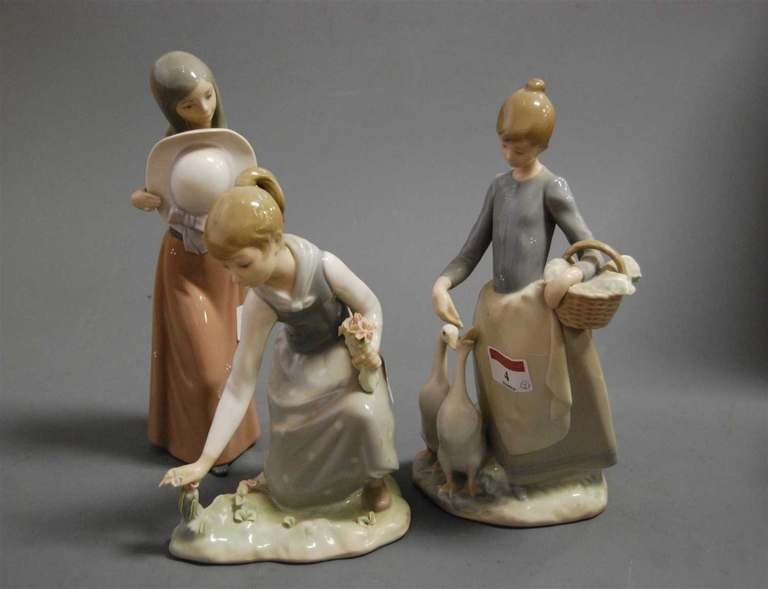 Lot 4 - A Lladro porcelain figure of a girl feeding...
