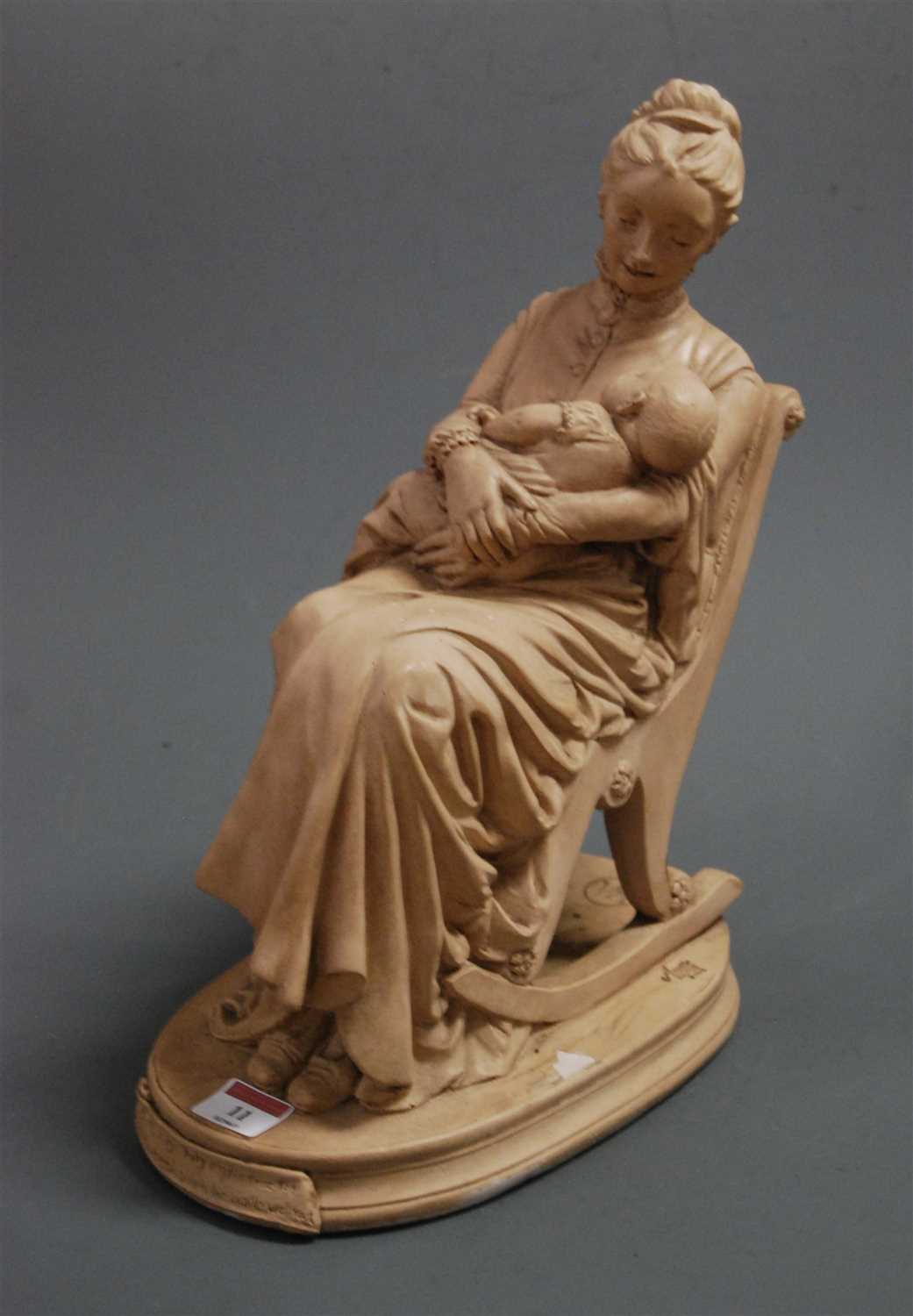 Lot 11 - A reproduction earthenware figure of a mother...