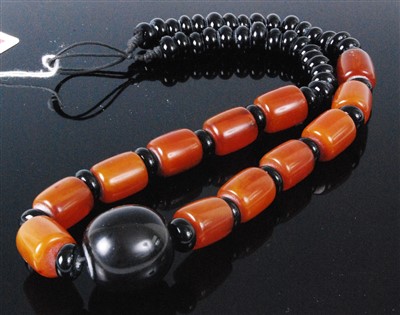 Lot 404 - A faux butterscotch amber and black bead...
