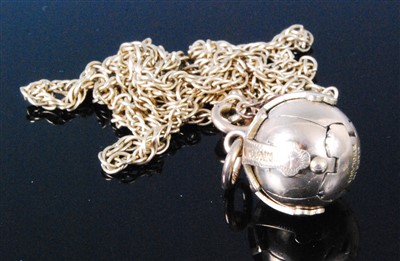Lot 420 - A gilt metal ball pendant on a finelink neck...