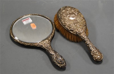 Lot 319 - A late Victorian silver mounted hand-mirror;...