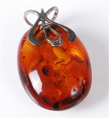 Lot 467 - A natural polished amber pendant with white...