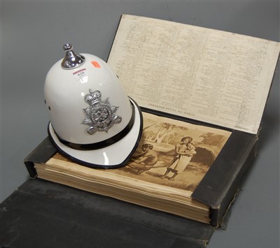 Lot 620 - A reproduction police helmet; together with a...