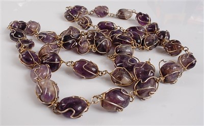 Lot 2521 - An opera length amethyst necklace, featuring...