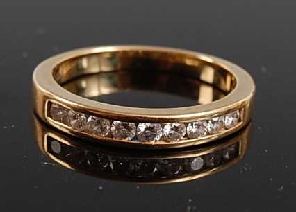 Lot 2539 - A yellow metal diamond half hoop eternity ring,...