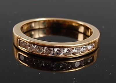 Lot 2539 - A yellow metal diamond half hoop eternity ring,...
