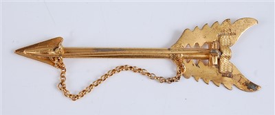 Lot 2547 - A yellow metal engraved bar brooch in the form...