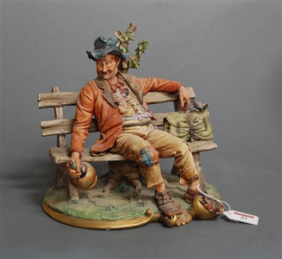 Lot 44 - A large Capo di Monte figure of a hobo seated...