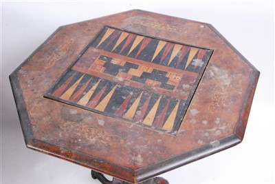 Lot 1415 - A Victorian figured walnut tripod games table,...